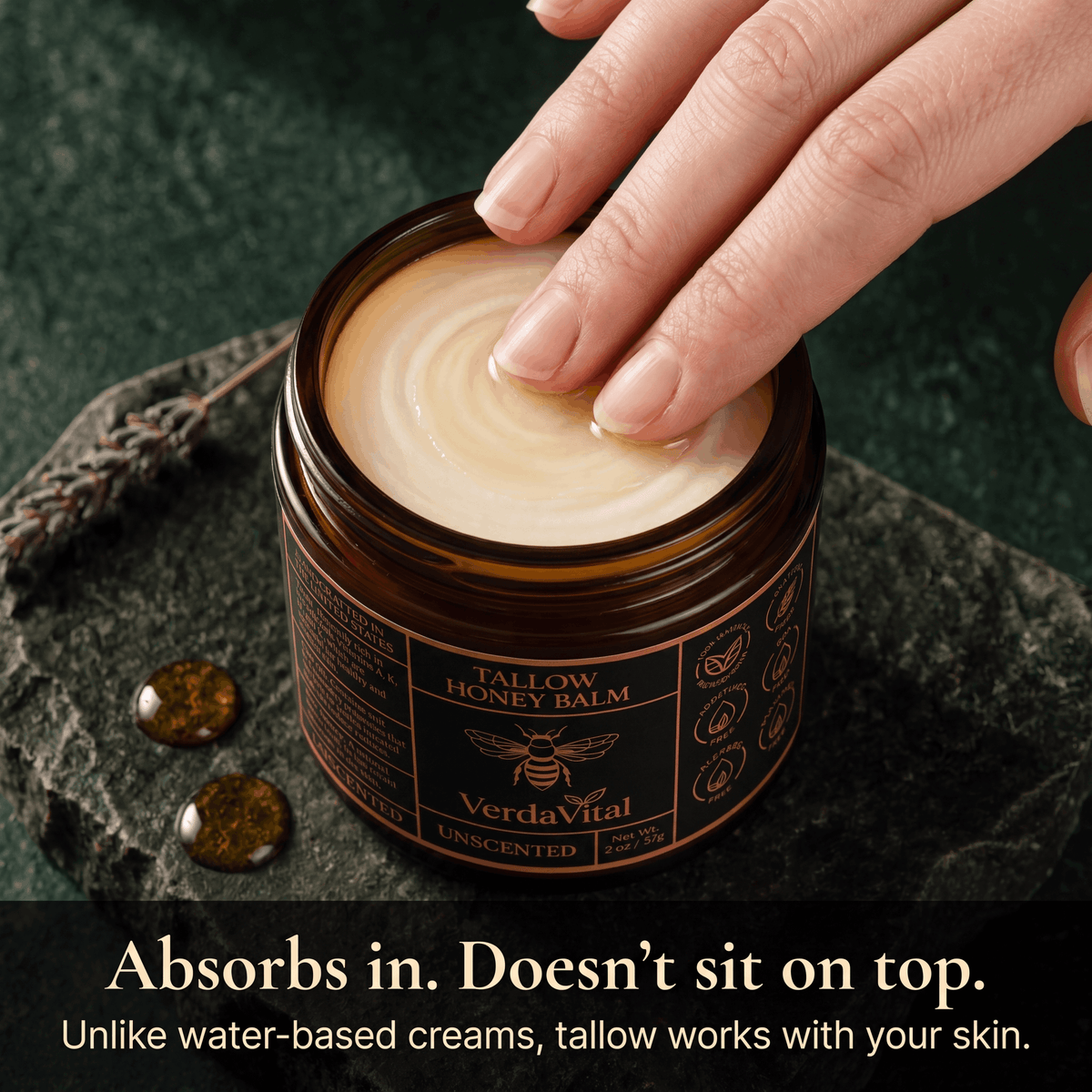 VerdaVital Honey Tallow Balm — scooping balm from open amber jar, showing rich cream texture